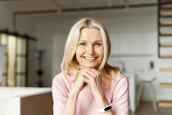 Smiling woman sitting in room