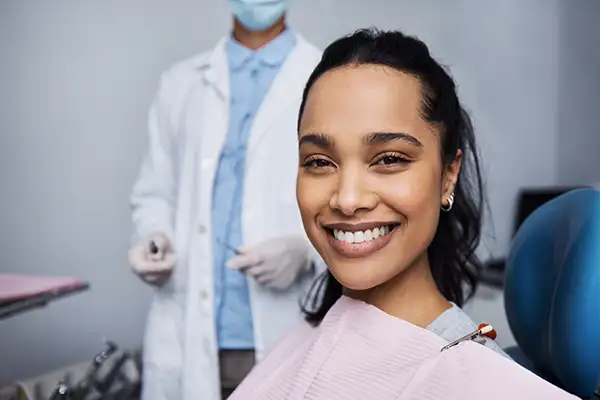 Smiling dental patient sitting in exam chair